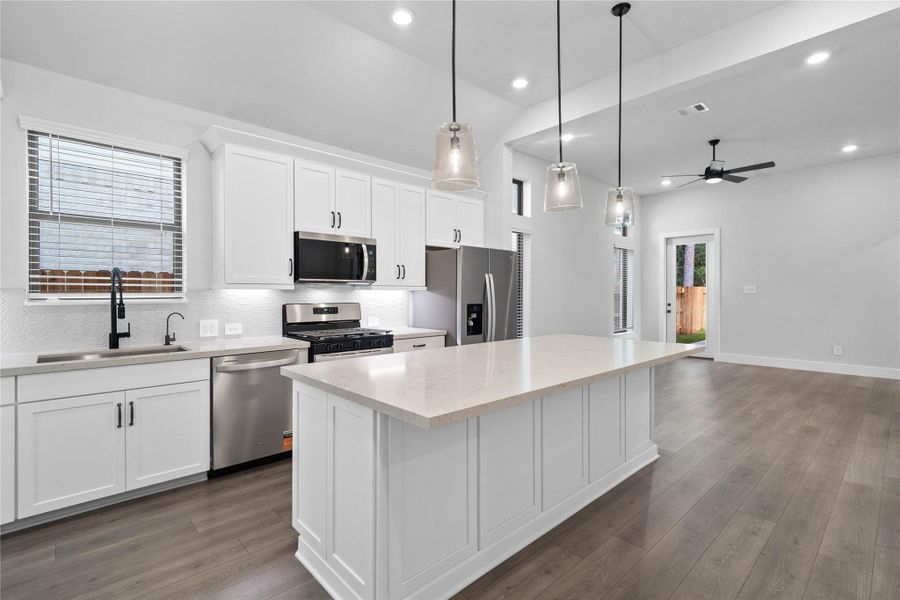 Elegant paneled details wrap the massive breakfast bar island, offering ample space for casual barstool seating and entertaining. Elegant paneled details wrap the massive breakfast bar island, offering ample space for casual barstool seating and entertaining.