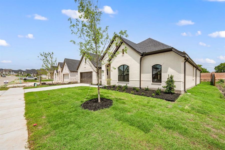 Front exterior of a new home in LeTara, Haslet, TX, highlighting curb appeal (Image 20).