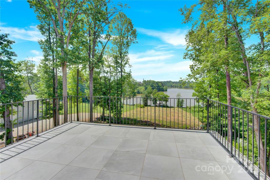 Walk out the upper level primary bedroom to your private lakefront balcony Walk out the upper level primary bedroom to your private lakefront balcony