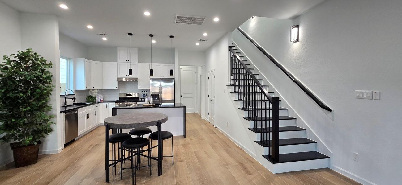 A contemporary staircase with dark accents adds a striking design element.
