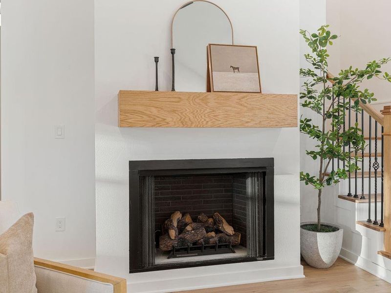 Detailed view of a fireplace and wood finished floors
