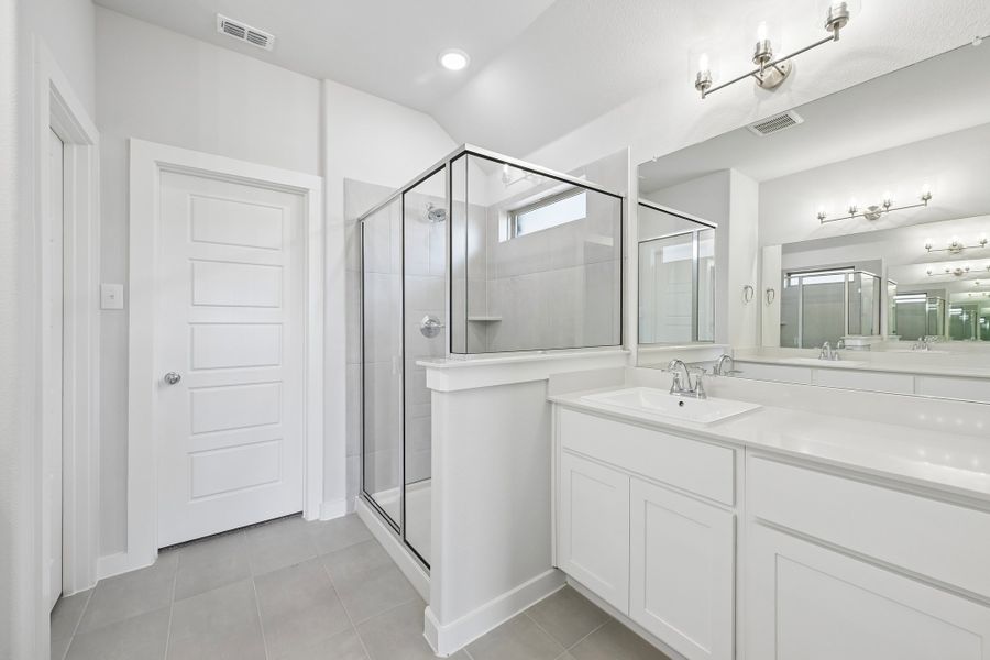 Primary Bathroom in the Heisman home plan by Trophy Signature Homes Primary Bathroom in the Heisman home plan by Trophy Signature Homes
