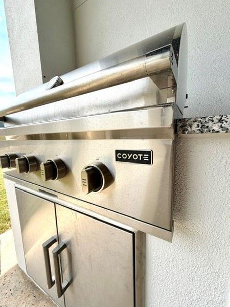 An outdoor grilling station with a built-in stainless steel Coyote grill. An outdoor grilling station with a built-in stainless steel Coyote grill.