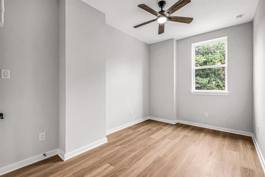 Guest bedroom with window overlooking the front yard.