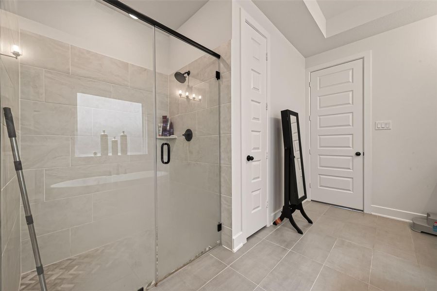 The spacious frameless glass shower adds a luxurious touch to the primary bathroom. The spacious frameless glass shower adds a luxurious touch to the primary bathroom.