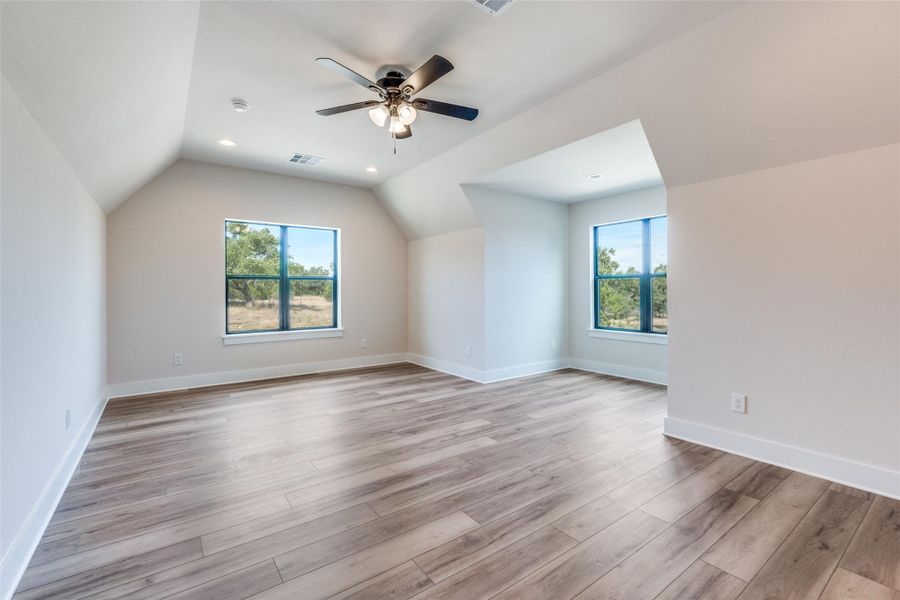 Bonus room featuring vaulted ceiling, ceiling fan, light wood-type flooring, and recessed lighting