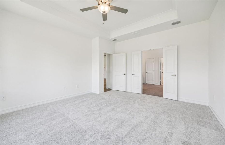 Spacious owner's suite highlighted by large windows and an exquisite tray ceiling *Real home pictured Spacious owner's suite highlighted by large windows and an exquisite tray ceiling *Real home pictured