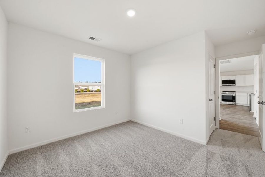 A room with a window and a rug. A room with a window and a rug.