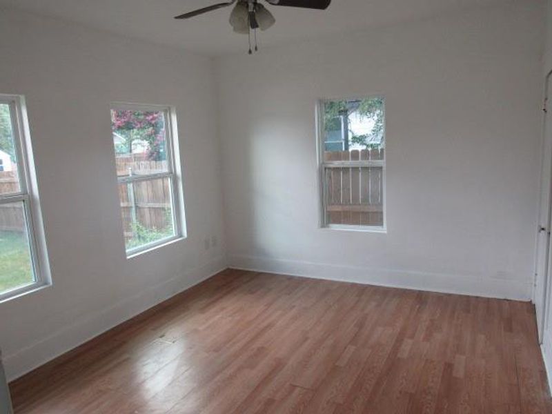 Unfurnished room with light wood finished floors and ceiling fan Unfurnished room with light wood finished floors and ceiling fan