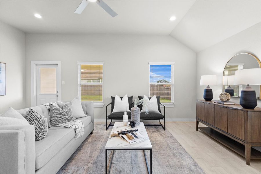 Bright living room offers a vaulted ceiling, recessed lighting, ceiling fan, multiple windows, and an open layout ideal for everyday living and entertaining. Bright living room offers a vaulted ceiling, recessed lighting, ceiling fan, multiple windows, and an open layout ideal for everyday living and entertaining.