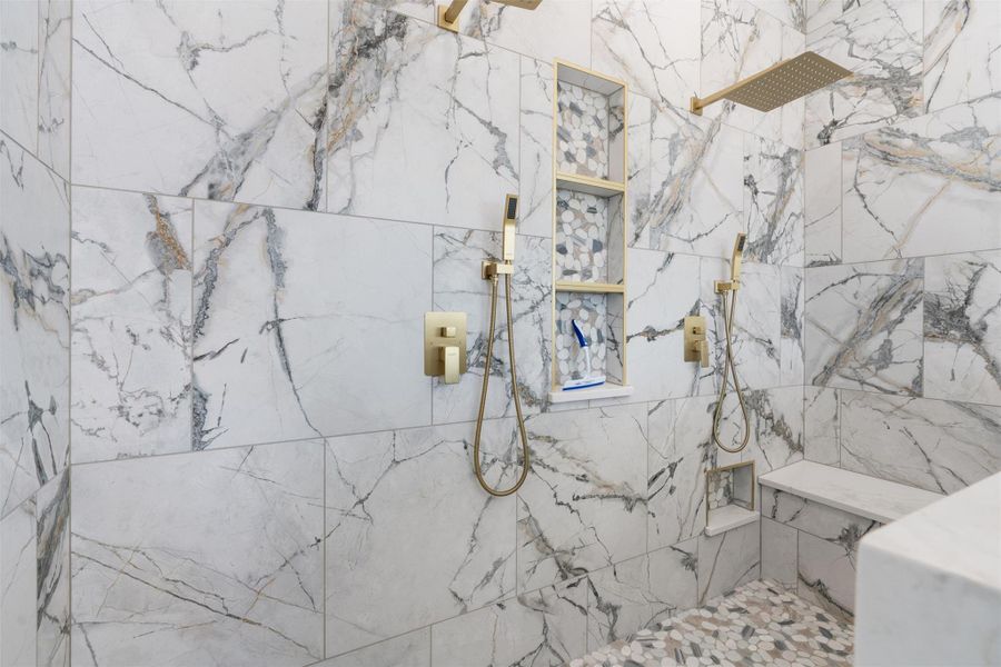 Full bath with a marble finish shower