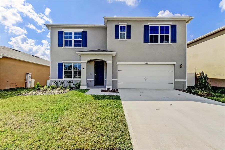Front exterior of a new home in Lakes at Laurel Highlands, Lakeland, FL, highlighting curb appeal (Image 30).
