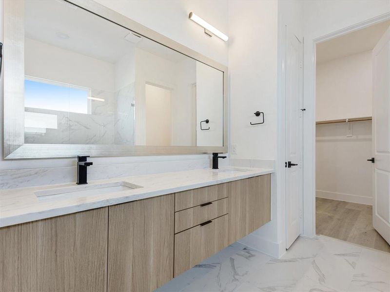 Primary Bathroom with light marble finish flooring, a spacious closet, and a marble finish shower Primary Bathroom with light marble finish flooring, a spacious closet, and a marble finish shower