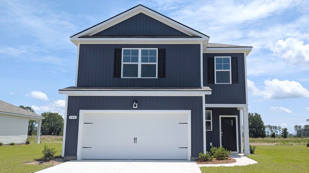 Front exterior of a new home in Pinewood Estates, Conway, SC, highlighting curb appeal (Image 1).