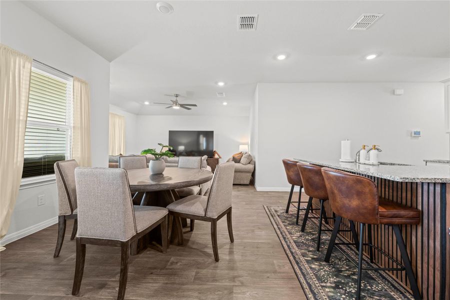An open-concept living area features warm wood flooring and inviting seating arrangements perfect for entertaining.