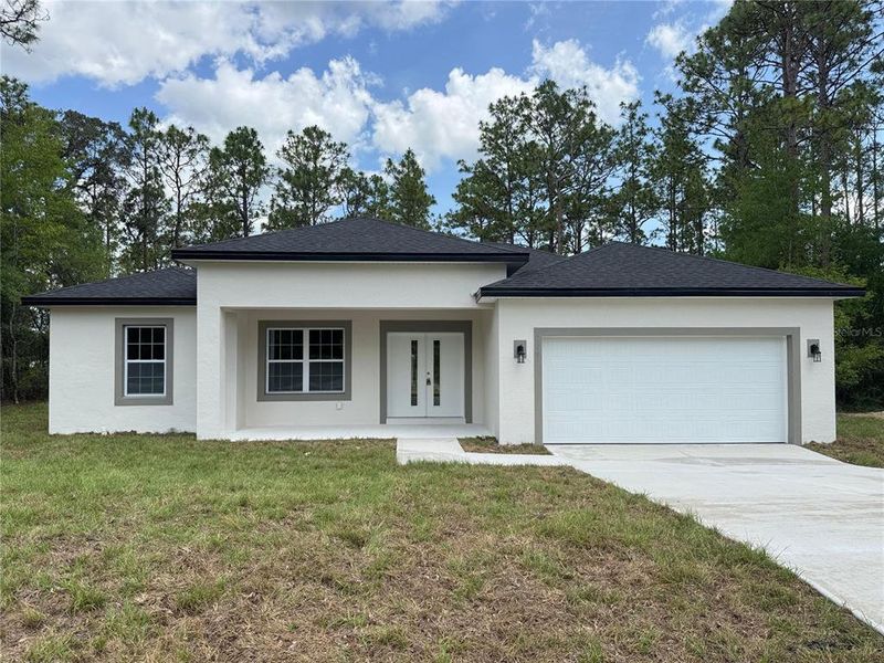 Front exterior of a new home in , Citrus Springs, FL, highlighting curb appeal (Image 18).