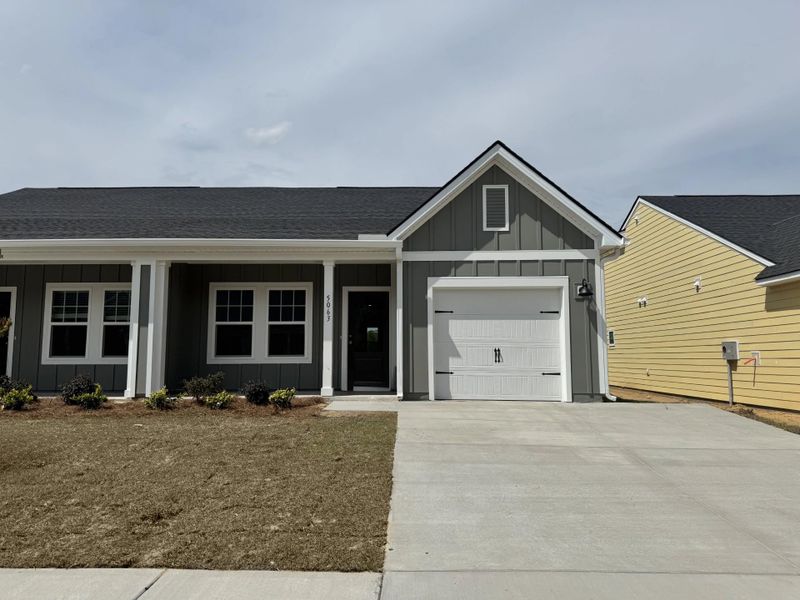 Front exterior of a new home in Tea Farm, Ravenel, SC, highlighting curb appeal (Image 13).