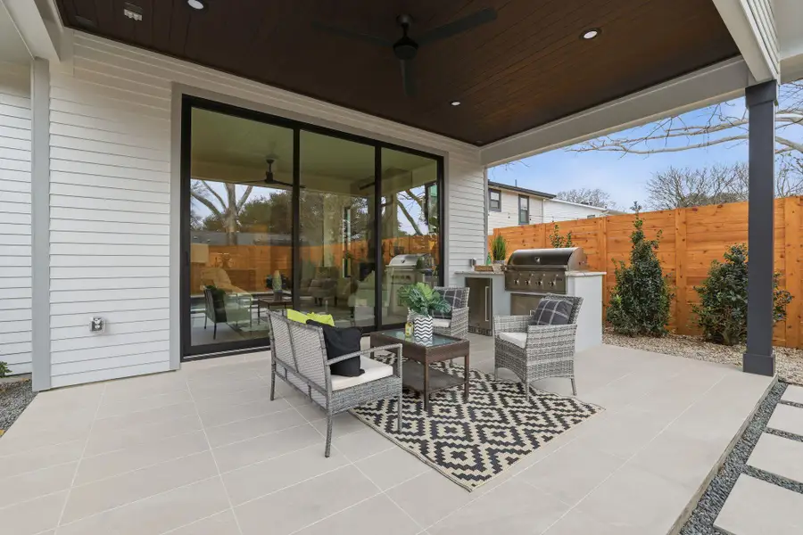 View of patio with a ceiling fan and an outdoor kitchen and area to lounge