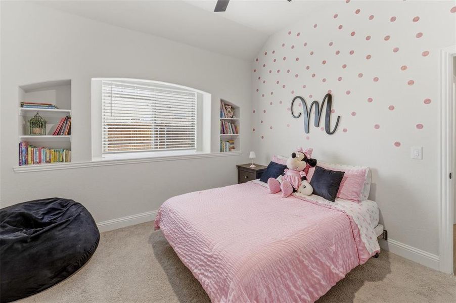 Bedroom featuring light carpet, ceiling fan, vaulted ceiling, and wallpapered walls