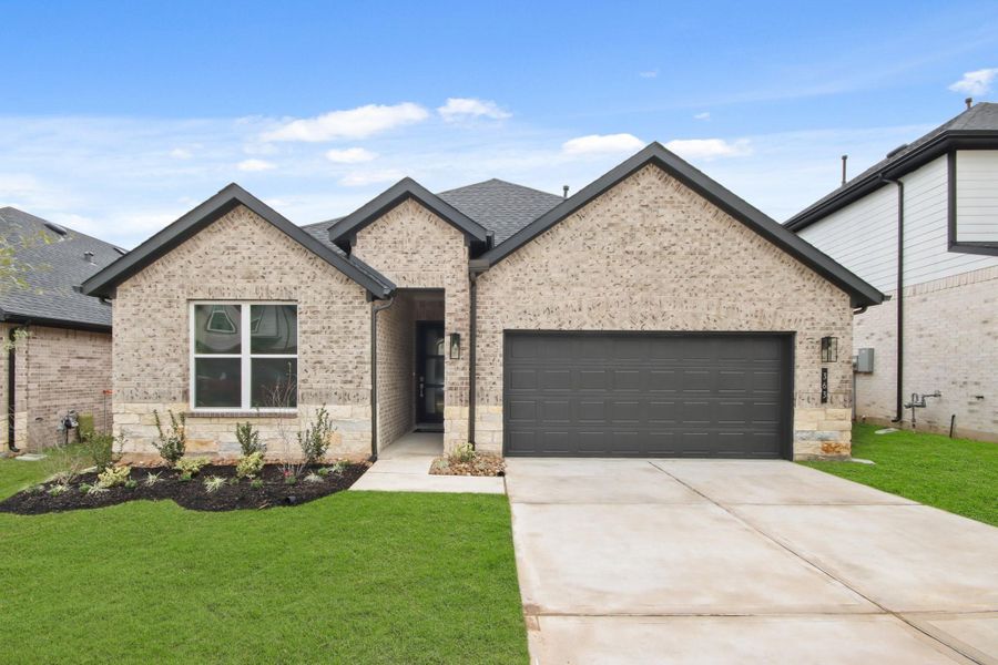 Front exterior of a new home in Hills of Westlake, Conroe, TX, highlighting curb appeal (Image 1). Front exterior of a new home in Hills of Westlake, Conroe, TX, highlighting curb appeal (Image 1).
