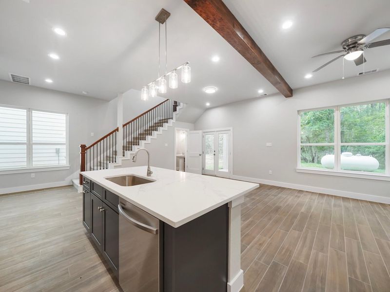 Kitchen is mix of navy blue island and white cabinets