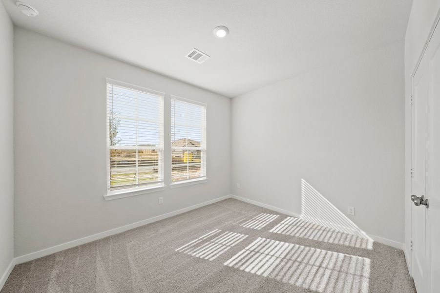 A room with a rug and a window. A room with a rug and a window.