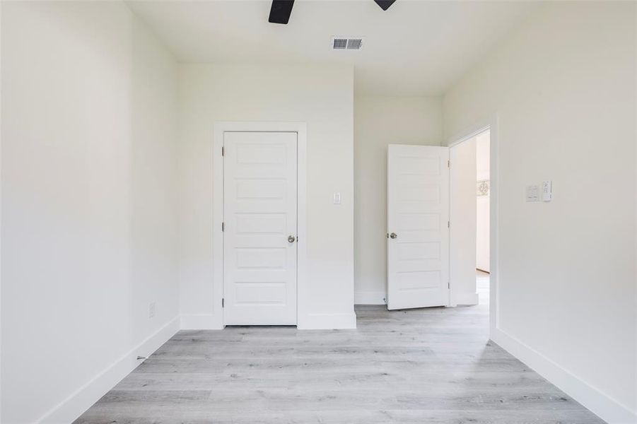Bedroom with light wood-type flooring and a ceiling fan