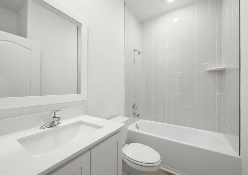 Second bathroom with tile detail around the tub