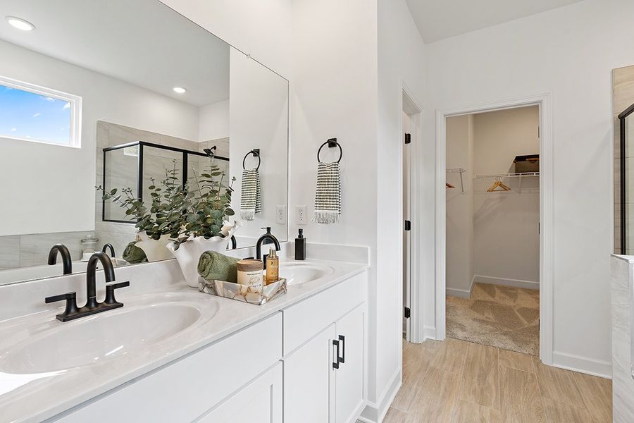 A bathroom with a sink and a mirror. A bathroom with a sink and a mirror.