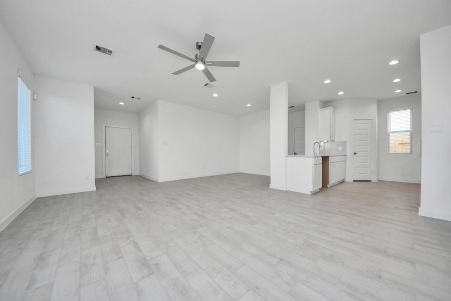 Take another glimpse into the heart of the home with this additional view of the family room—a sprawling space ready to accommodate all your gatherings. Sample photo of completed home with similar floor plan. Actual colors and selections may vary.