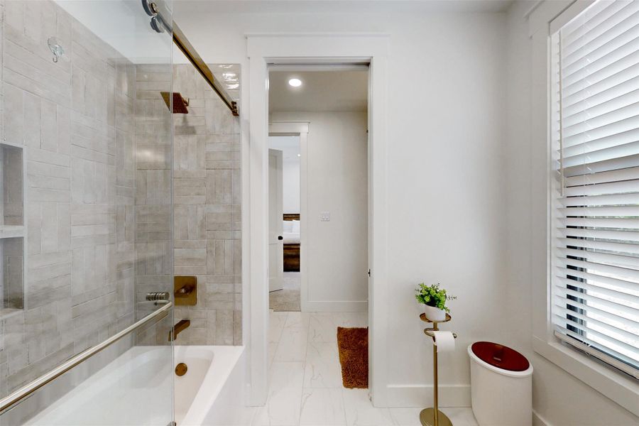 Full bath featuring marble look tile flooring, shower / washtub combination, and recessed lighting combination and marble finish floors