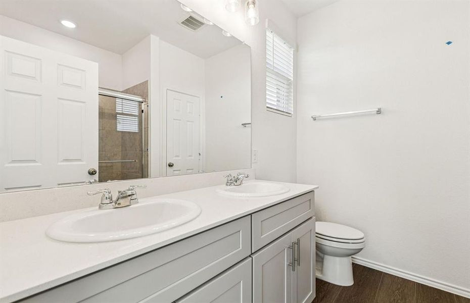 Elegant owner's suite with dual vanity *real home pictured Elegant owner's suite with dual vanity *real home pictured