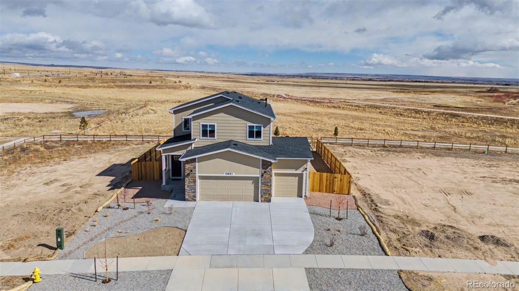 Front exterior of a new home in , Peyton, CO, highlighting curb appeal (Image 2). Front exterior of a new home in , Peyton, CO, highlighting curb appeal (Image 2).