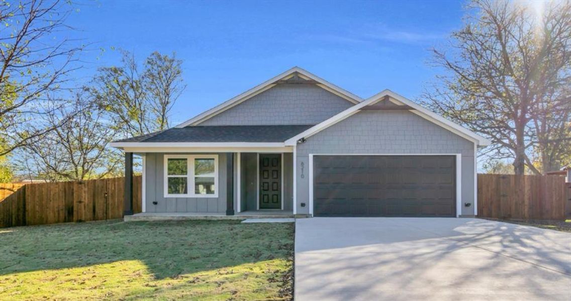Front view of home with driveway, 30 year composite shingles, board and batten siding, covered porch, and an attached 2-car garage siding, driveway, and 2-car garage