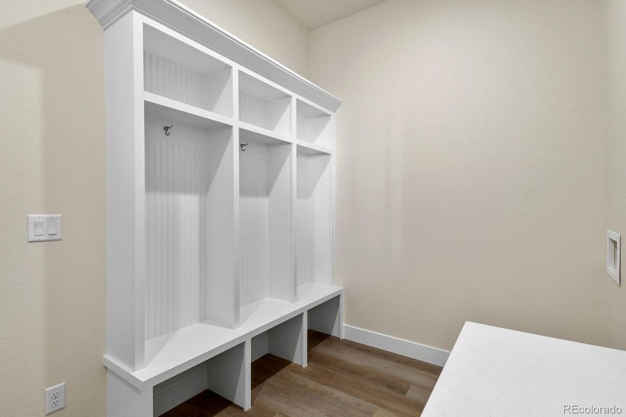Mudroom/laundry area adds everyday convenience with built-in storage and direct access to the garage.