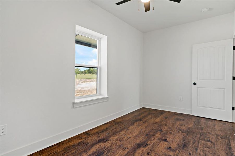 Unfurnished room with ceiling fan and hardwood / wood-style floors