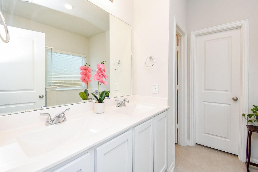Primary bathroom with dual vanities and ample counter space. Primary bathroom with dual vanities and ample counter space.