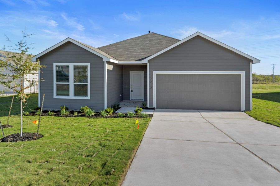 Front exterior of a new home in Schriber Ranch, Mustang Ridge, TX, highlighting curb appeal (Image 1). Front exterior of a new home in Schriber Ranch, Mustang Ridge, TX, highlighting curb appeal (Image 1).