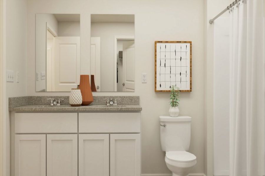 A bathroom with a sink toilet and mirror. A bathroom with a sink toilet and mirror.