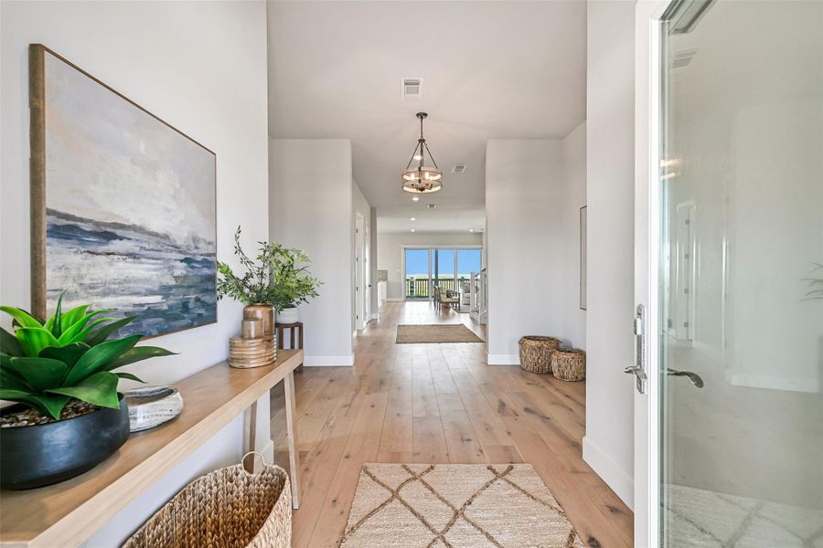 Step inside and see the home’s seamless flow from the main entrance. The luxury white oak hardwood floors stretch throughout, creating warmth and sophistication underfoot. Wide-open spaces, natural light, and luxury finishes guide your eye from living areas to kitchen and beyond—perfect for sleek, elegant living.