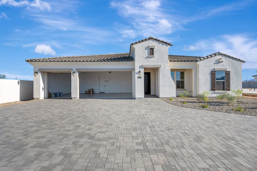 Front exterior of a new home in Sentiero at Windrose, Waddell, AZ, highlighting curb appeal (Image 2). Front exterior of a new home in Sentiero at Windrose, Waddell, AZ, highlighting curb appeal (Image 2).
