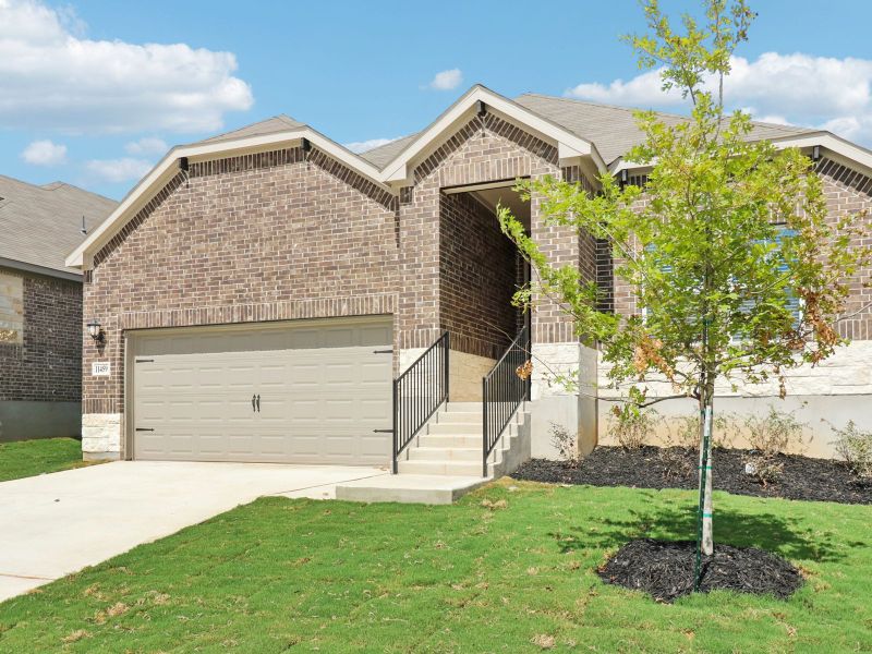 Front exterior of a new home in Sagebrooke - Classic Series, San Antonio, TX, highlighting curb appeal (Image 22). Front exterior of a new home in Sagebrooke - Classic Series, San Antonio, TX, highlighting curb appeal (Image 22).