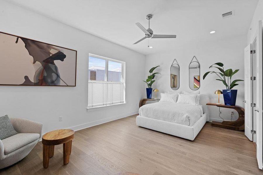 Bedroom with light wood-style flooring, ceiling fan, and recessed lighting