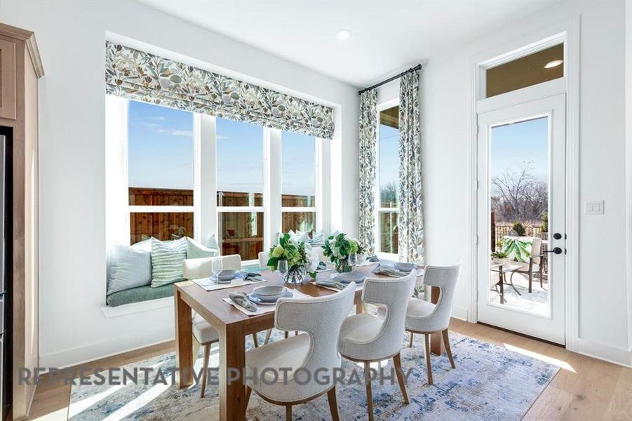 Dining space with light wood-style flooring, healthy amount of natural light, and recessed lighting
