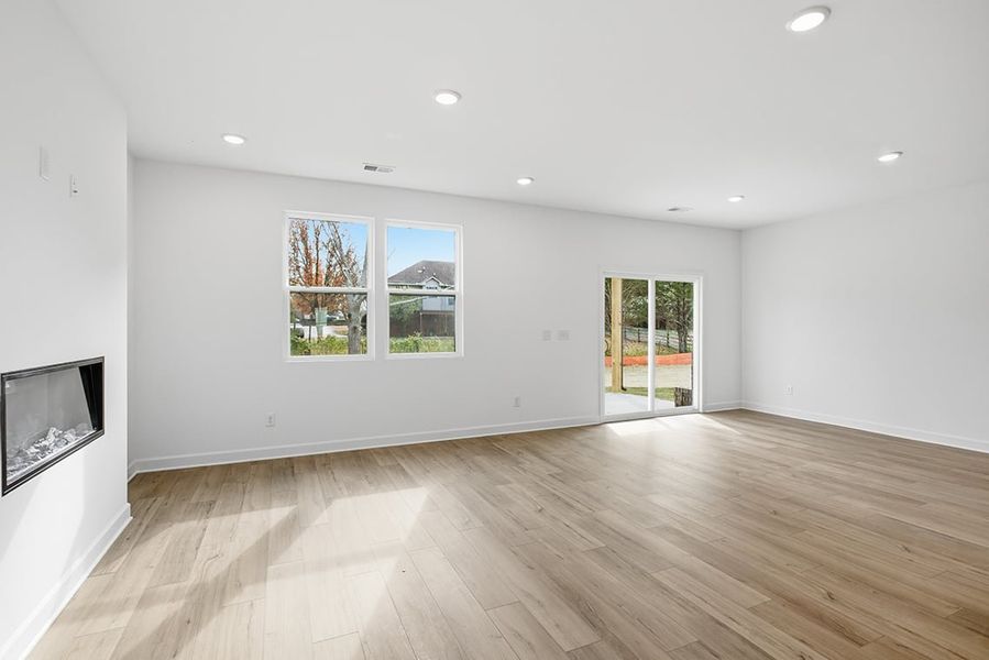 A room with a wood floor and windows. A room with a wood floor and windows.