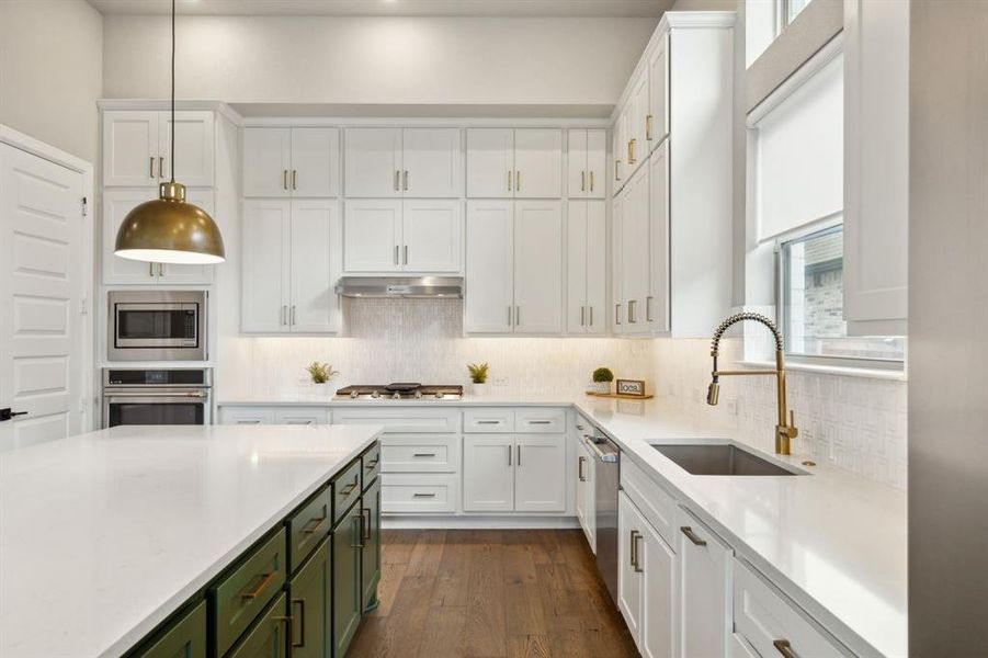 Kitchen featuring plenty of natural light, dark hardwood / wood-style flooring, stainless steel appliances, and sink