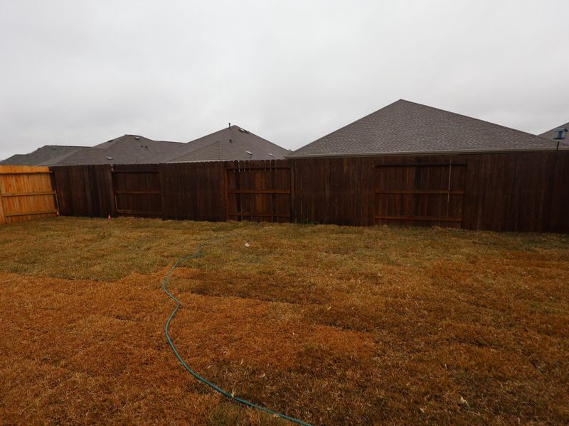 Exterior details and patio area of a home in Pinewood at Grand Texas, New Caney (Image 4).