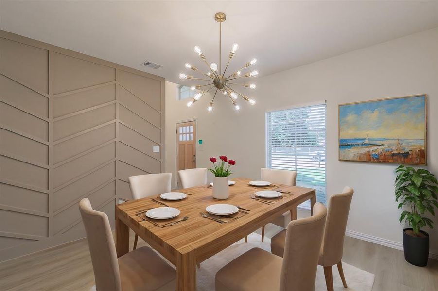 Dining area with an inviting chandelier and light hardwood / wood-style flooring