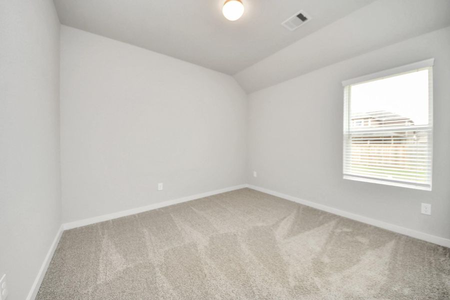 Secondary bedroom features plush carpeting, large windows that let in plenty of natural light, bright paint, and spacious closets. Sample photo of completed home with similar floor plan. Actual colors and selections may vary. Secondary bedroom features plush carpeting, large windows that let in plenty of natural light, bright paint, and spacious closets. Sample photo of completed home with similar floor plan. Actual colors and selections may vary.