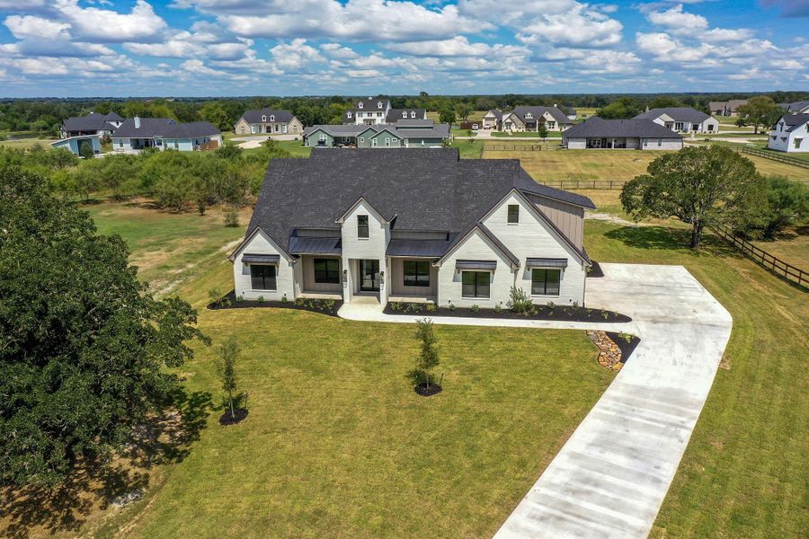 Front exterior of a new home in , Bryan, TX, highlighting curb appeal (Image 23).